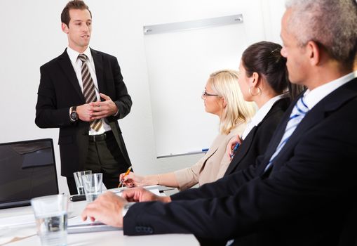 Businessman giving a presentation to his colleagues