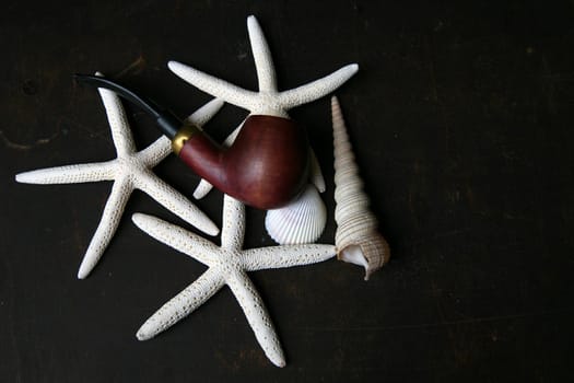 few starfishes, shell and a pipe