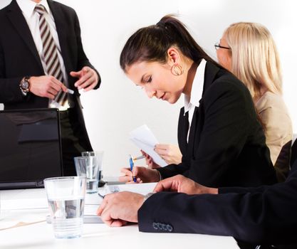 Young businesswomen taking notes at the presentation