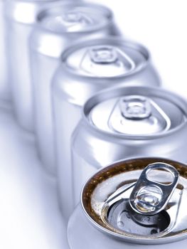 Close up view of a row of soda cans. Shallow depth of field.