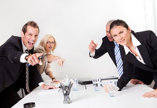 Four angry business people screaming at camera