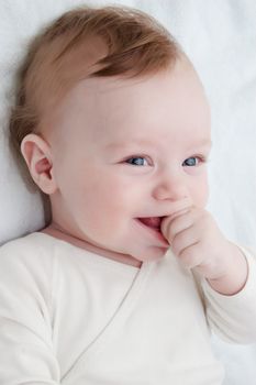Adorable laughing baby boy over white
