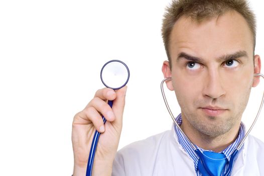 concerned young male doctor holding stethoscope in hand