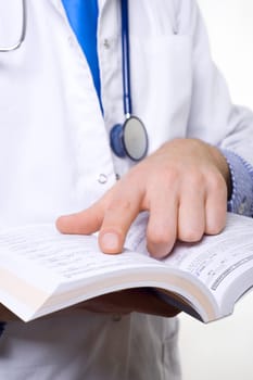 male doctor with stethoscope reading medical book