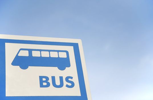 bus stop sign over the blue sky
