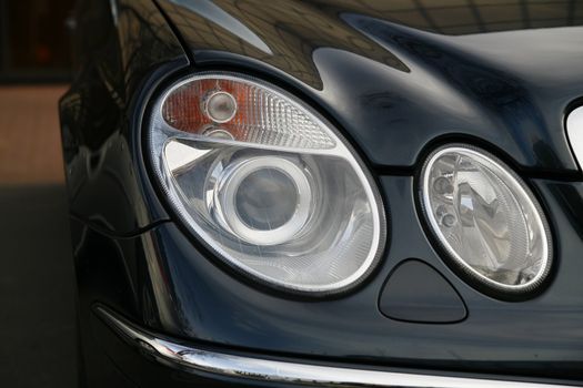 headlamp of a new car in dealer salon