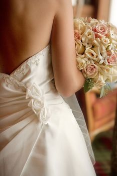 A back view of a bride with her bouquet