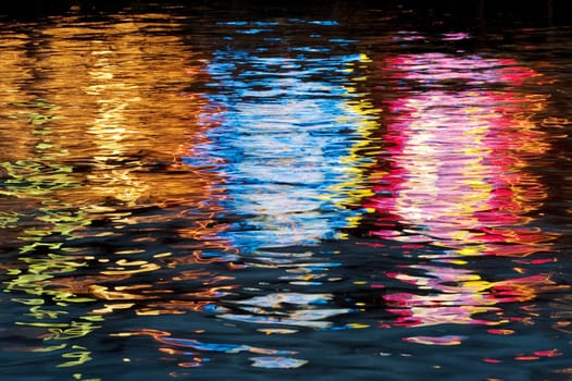 Colorful light reflection off water surface
