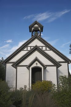 An old church building stands against a blue, Colorado sky.