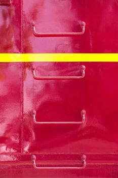 Metal ladder rungs on the side of red train caboose