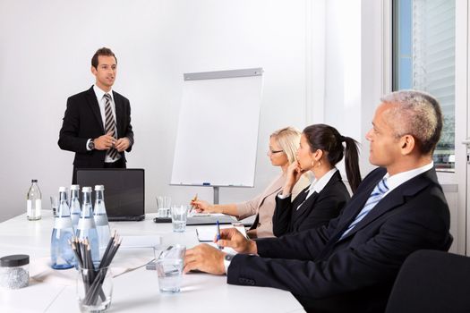 Businessman giving a presentation to his colleagues