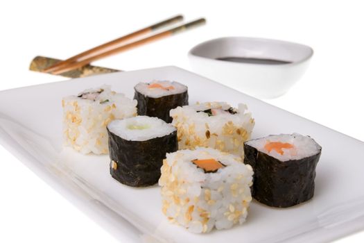 Sushi rolls, wooden chopsticks and soy sauce. Isolated on white