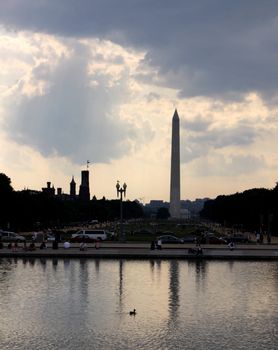 The Washington monument in the distance reflecting in a pool.

