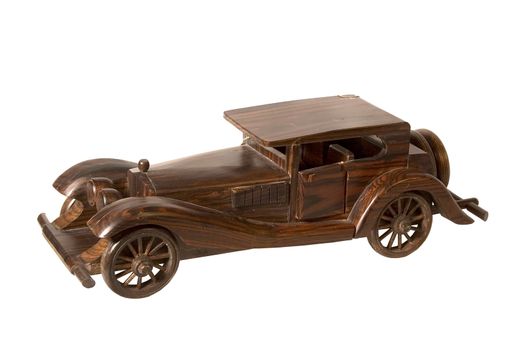 The wooden model of the retrocar executed from an integral piece of a dark tree and covered with a varnish
