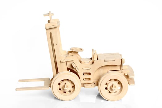 The wooden model of a tractor executed from plywood

