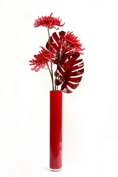 Bouquet in a vase from red artificial flowers