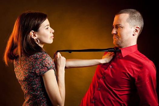 Playful beautiful young woman and her boyfriend. Studio shot