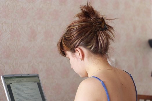 beautiful young woman works at the computer