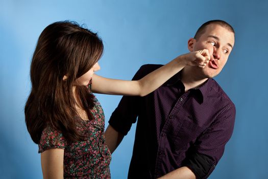 Young woman punching men in a face