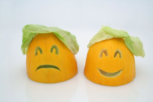 two melons - happy and sad with a salad as a hair
