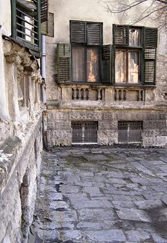 Detail from old city, old house corner, reflection in windows.