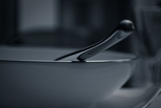 Modern glasses and plates on the glass table with light soft