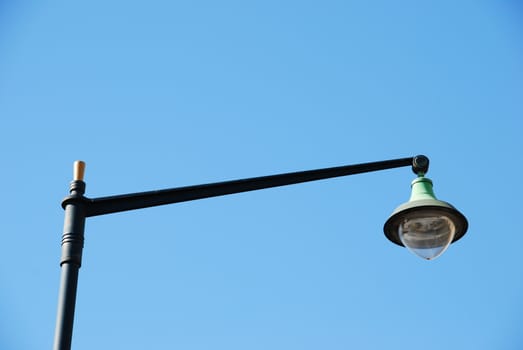 vintage lamp post against blue sky background