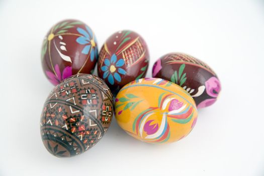 five painted eggs on whie background