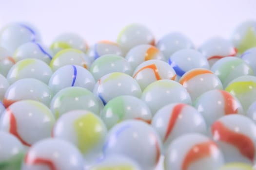 Heap of ceramic multi-coloured balls removed close up