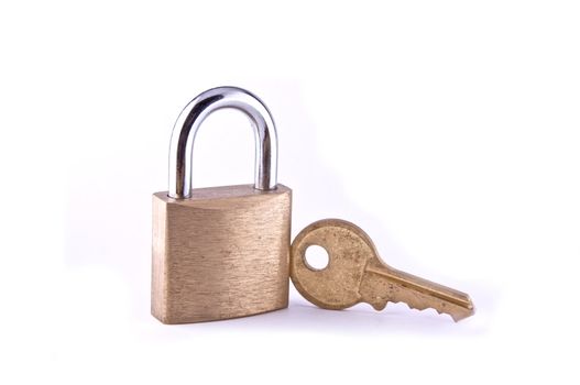 A brass padlock with key isolated on white