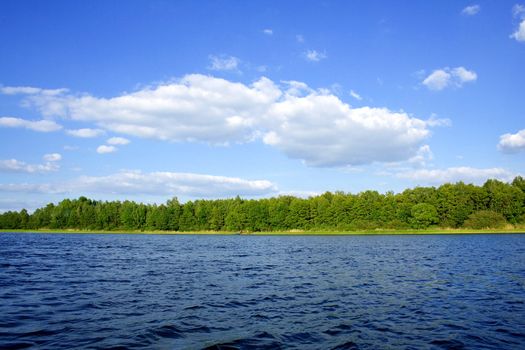 blue sky with white clouds over blue water (Poland)