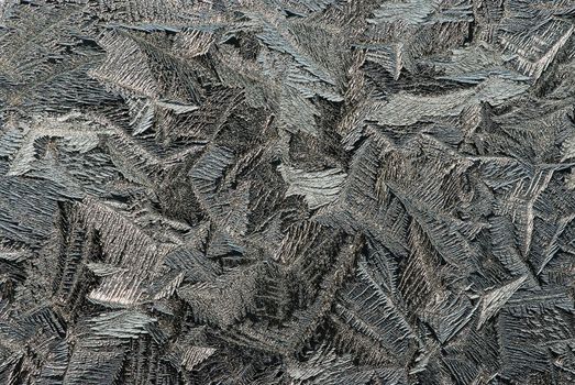 Hoarfrost on glass, texture of ice in thee cold winter.