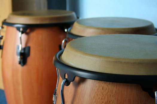 three old bongos made of wood and leather