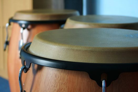 three old bongos made of wood and leather