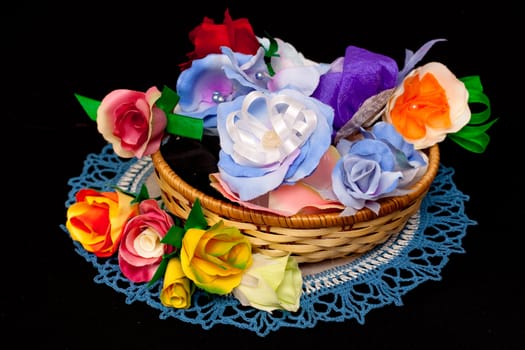 artificial handmade roses in basket on black
