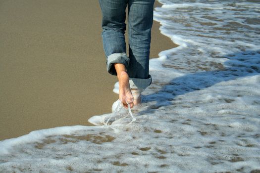 lonely woman walking on the beach