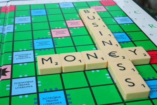 inscription business and money made of scrabble tiles. in the middle there is Euro symbol