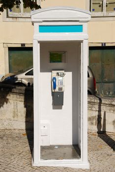 typical white telephone booth in Lisbon, Portugal