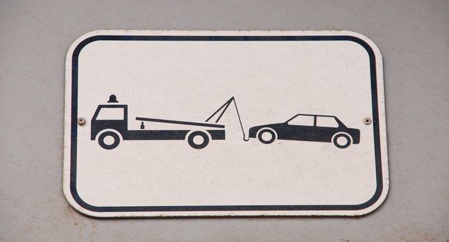 gray and black vehicles towing sign