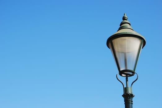 vintage lamp post against blue sky background