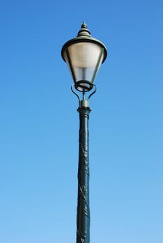 vintage lamp post against blue sky background