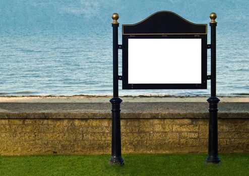 an image of a signpost situated against a wall at a sunny beach.