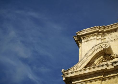 A medieval limestone facade in traditional Gothic style in Mdina on the island of Malta