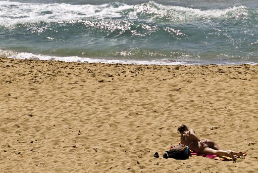 Woman in bikini at the beach in spring in Malta