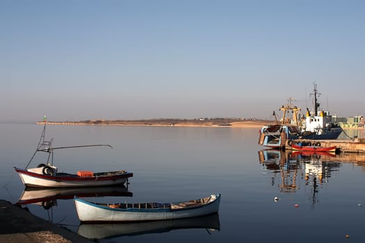 Two fisherman boats on berth with sea