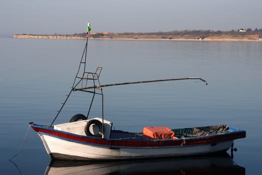 Fisherman boat in berth on anchor