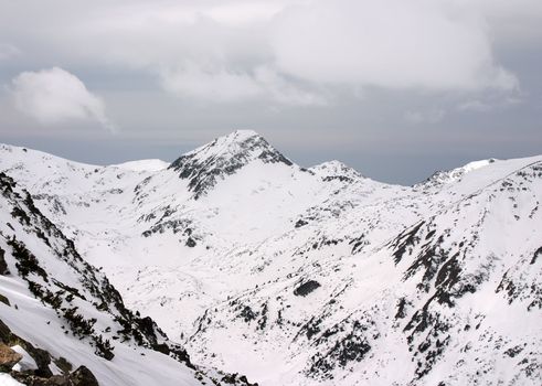 Margin in Pirin mountains with sky and snow