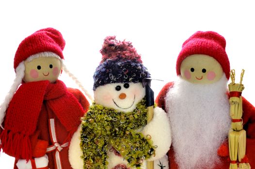 Wooden Father and Mother Christmas dolls with a snowman, on a white background. Space for text.