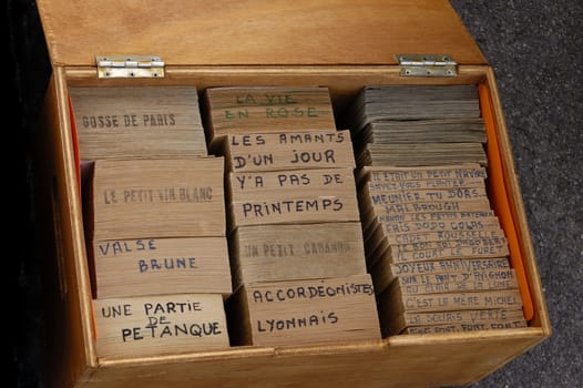 A box of punched-card strips, music tapes for an old French barrel organ. An original computing system using punched cards, over 100 years old.