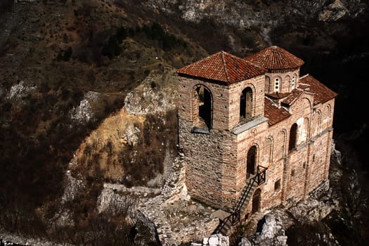 Little church on cliff rock in mointains